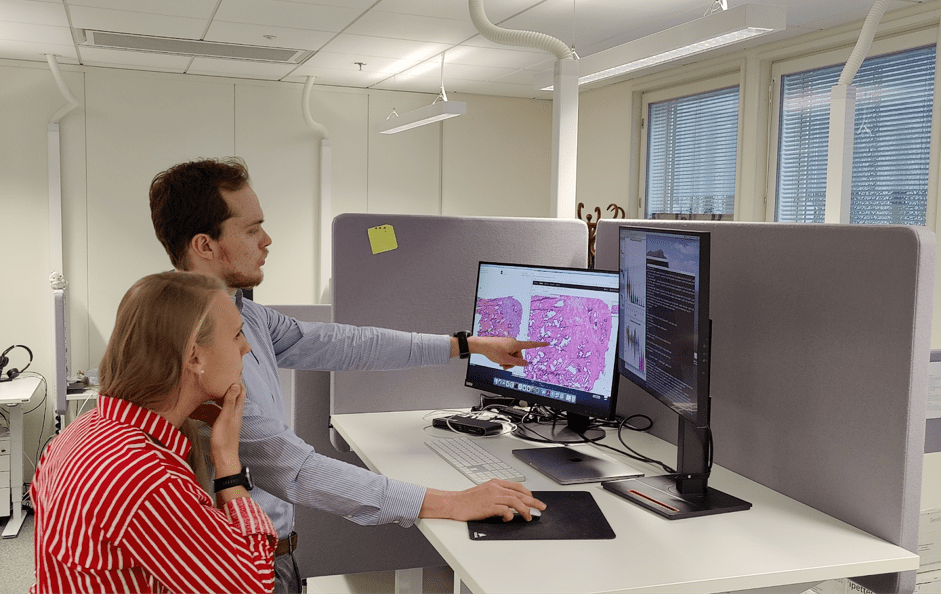 Researchers inspecting the Visium images and the gene expression data at the computer